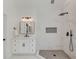 Contemporary bathroom featuring marble tiling, a rainfall shower, and a sleek vanity with black fixtures at 12340 Preserve Ln, Alpharetta, GA 30005