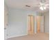Neutral bedroom with ceiling fan and multiple doors, providing space, convenience, and great flow at 12340 Preserve Ln, Alpharetta, GA 30005