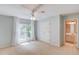 Bedroom with neutral paint, carpet, and ceiling fan. Double doors to closet, and entry to bathroom at 12340 Preserve Ln, Alpharetta, GA 30005