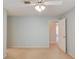 Neutral bedroom with light paint, carpet, and ceiling fan; doorway in back leads to another room at 12340 Preserve Ln, Alpharetta, GA 30005