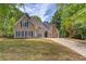 Charming two-story home featuring a manicured lawn, neutral siding, blue shutters, and a stone chimney at 12340 Preserve Ln, Alpharetta, GA 30005