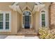 Welcoming front entrance with a dark door, wreath, stone walkway, and decorative columns at 12340 Preserve Ln, Alpharetta, GA 30005