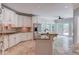 Well-equipped kitchen boasts granite countertops, white cabinetry, and stainless-steel appliances at 12340 Preserve Ln, Alpharetta, GA 30005