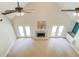 Living room with high vaulted ceilings, ceiling fans, fireplace, and doors that lead to the deck at 12340 Preserve Ln, Alpharetta, GA 30005