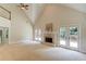 Spacious living room boasts vaulted ceilings, fireplace, and access to outdoor deck at 12340 Preserve Ln, Alpharetta, GA 30005