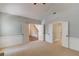 Spacious living room featuring neutral carpet, wainscoting, a vaulted ceiling, and multiple doorways at 12340 Preserve Ln, Alpharetta, GA 30005