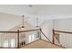 Upstairs loft area overlooking the living room below with high vaulted ceilings and ceiling fans at 12340 Preserve Ln, Alpharetta, GA 30005