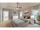 Stylishly furnished main bedroom with tray ceiling, ensuite access, and a calm, neutral color palette at 12340 Preserve Ln, Alpharetta, GA 30005