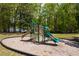Community playground with slides and climbing area, surrounded by trees and green space at 12340 Preserve Ln, Alpharetta, GA 30005