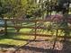 Picturesque backyard showcases a wooden fence and mature trees for privacy and natural beauty at 1424 Belmont Rd, Villa Rica, GA 30180