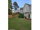 Backyard view of a well maintained yard, fenced area, and a deck at 1424 Belmont Rd, Villa Rica, GA 30180