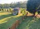 Large backyard with shed, mature trees, and fenced perimeter at 1424 Belmont Rd, Villa Rica, GA 30180