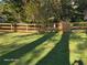 Fenced backyard with a meticulously maintained lawn with beautiful trees at 1424 Belmont Rd, Villa Rica, GA 30180