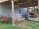 Covered backyard area with swing, rose bushes, and access to stairs at 1424 Belmont Rd, Villa Rica, GA 30180