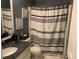 Bathroom with dark blue walls, a white shower curtain, and a matching granite countertop at 1424 Belmont Rd, Villa Rica, GA 30180