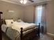 Neutral colored bedroom is lightly staged with bed and window at 1424 Belmont Rd, Villa Rica, GA 30180