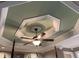 Detailed view of a bedroom's tray ceiling with a decorative medallion and lighted ceiling fan at 1424 Belmont Rd, Villa Rica, GA 30180