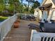 Expansive deck with lounge chair, dining set, grill, and potted plants for outdoor living at 1424 Belmont Rd, Villa Rica, GA 30180
