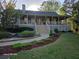 Beautiful home featuring a spacious front porch, well-manicured lawn, and attractive landscaping at 1424 Belmont Rd, Villa Rica, GA 30180