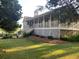 Charming home featuring a full front porch, a well-manicured lawn, and mature landscaping at 1424 Belmont Rd, Villa Rica, GA 30180