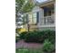 The home's exterior features black shutters, green siding and an inviting covered front porch at 1424 Belmont Rd, Villa Rica, GA 30180