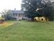Charming single-story home featuring a large front yard with mature trees and a welcoming porch at 1424 Belmont Rd, Villa Rica, GA 30180