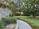 Spacious front yard with stone walkway, garden bed, and covered porch at 1424 Belmont Rd, Villa Rica, GA 30180