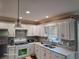 Modern kitchen featuring white cabinets, stainless steel appliances, and a stylish backsplash at 1424 Belmont Rd, Villa Rica, GA 30180