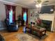Bright living room featuring a fireplace, built-in shelves, and large window with elegant drapes at 1424 Belmont Rd, Villa Rica, GA 30180