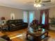 Comfortable living room boasts hardwood floors, a ceiling fan, and access to the outdoors at 1424 Belmont Rd, Villa Rica, GA 30180