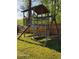 Wooden playground structure with swings and playhouse in backyard at 1424 Belmont Rd, Villa Rica, GA 30180