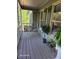 Inviting front porch with a swing, wood floors, and views of mature shade trees at 1424 Belmont Rd, Villa Rica, GA 30180
