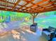 This serene backyard features a covered patio with comfortable seating and forest views at 210 Arbor Creek Dr, Dallas, GA 30157