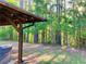 Charming backyard with covered patio and peaceful wooded views at 210 Arbor Creek Dr, Dallas, GA 30157