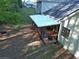 Aerial shot of backyard with covered patio featuring lounge area and fire pit at 210 Arbor Creek Dr, Dallas, GA 30157