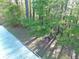 There is a backyard with a swing hanging from the trees at 210 Arbor Creek Dr, Dallas, GA 30157