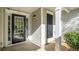 A home's entrance with a black front door and a decorative pillar at 210 Arbor Creek Dr, Dallas, GA 30157