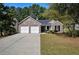 Charming single-story brick home with a well-manicured lawn and a two-car garage at 210 Arbor Creek Dr, Dallas, GA 30157