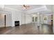 Open living space featuring a fireplace, lots of natural light, and wood-look floors at 210 Arbor Creek Dr, Dallas, GA 30157