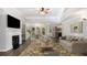 Bright living room with a fireplace, ceiling fan, and an open dining area at 210 Arbor Creek Dr, Dallas, GA 30157