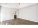 Neutral main bedroom with hardwood-style floors and access to ensuite bathroom at 210 Arbor Creek Dr, Dallas, GA 30157