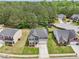 Aerial shot of a suburban home nestled among lush trees, showcasing its well-maintained lawn and inviting neighborhood at 6904 Estepona St, Atlanta, GA 30349