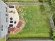 Aerial image of backyard featuring patio with furniture, small garden, and large grassy area at 6904 Estepona St, Atlanta, GA 30349
