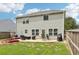 Large, fenced backyard with a patio and garden beds provides ample space for outdoor activities at 6904 Estepona St, Atlanta, GA 30349