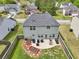 Aerial view of a fenced backyard with patio, outdoor seating, and a small garden area at 6904 Estepona St, Atlanta, GA 30349