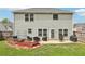 Well-maintained backyard features a cozy patio with outdoor seating and a garden area, perfect for relaxing or entertaining at 6904 Estepona St, Atlanta, GA 30349