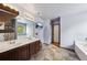 Bright bathroom with a double vanity, soaking tub, and a wall-mounted TV at 6904 Estepona St, Atlanta, GA 30349