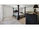 Spacious bedroom featuring a four-poster bed, a dark dresser, and neutral carpeting at 6904 Estepona St, Atlanta, GA 30349