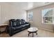 Bonus room is furnished with a plush black leather sofa at 6904 Estepona St, Atlanta, GA 30349