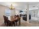 Open-concept dining room flows into a living area with natural light and an ornate chandelier at 6904 Estepona St, Atlanta, GA 30349